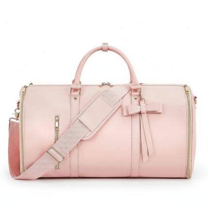 Pink Mova Luxe travel duffle with signature bow detail and PU leather exterior
